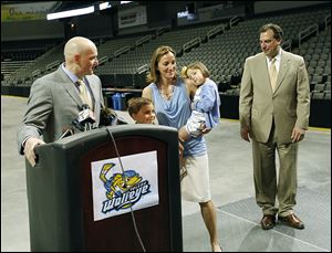 New Walleye coach Derek Lalonde speaks at a news conference alongside his sons Luke, 5, mostly hidden, and Alex, 8, wife Melissa, and daughter Abby, 3. He previously coached in the USHL.