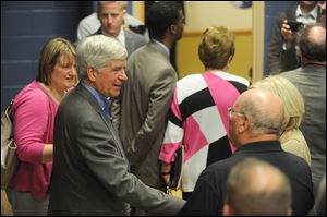 Michigan Gov. Rick Snyder shakes hands with leaders from nonprofits, businesses, and adult advocacy organizations Monday at the Older Persons Commission in Rochester, Mich. The governor gave a special message on aging.