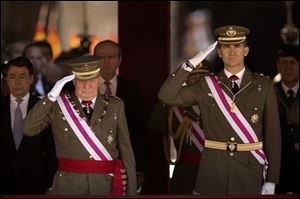 King Juan Carlos and Crown Prince Felipe, right, attend a military ceremony in San Lorenzo de El Escorial, outside Madrid, Spain, on June 3, 2014.