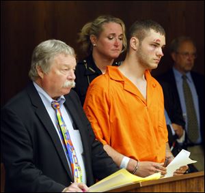 Attorney James McHarg, left, stands with Timothy Antoine who is charged with felonious assault, failure to comply, obstructing official business, and resisting arrest.