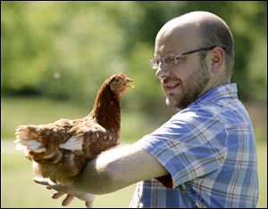 Joel Mazur of Waterville and his chicken Nancy Pelosi won the Pet Idol contest during the ninth annual MetroBarks Festival at Swan Creek Preserve Metropark in Toledo. Mr. Mazur’s hen topped 102 entries to claim the title.