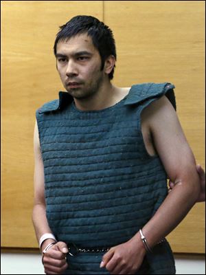 Shooting suspect Aaron Ybarra, left, is led in chains to a court hearing Friday at a King County Jail courtroom in Seattle. 