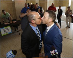 Rich Gillard, left, and Andrew Petroll kiss after their marriage ceremony at the Milwaukee County Courthouse.