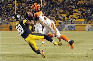 Cincinnati Bengals cornerback Adam Jones intercepts a pass intended for Pittsburgh Steelers wide receiver Emmanuel Sanders in a Sunday night NFL game Dec. 15 in Pittsburgh. NBC’s ‘‍Sunday Night Football’ was the highest rated show overall and among viewers 18 to 49.