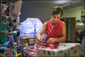 Dr. Gagandeep Brar of Mercy Children’s Hospital examines a baby in the neonatal intensive care unit. Some opiate-addicted babies are given methadone to stabilize them and stop withdrawal symptoms.