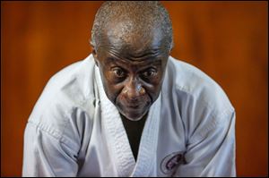 Lowell Cherry, Jr., bows as he teaches jukido jujitsu. Mr. Cherry hopes to earn his fifth-degree black belt later this year.