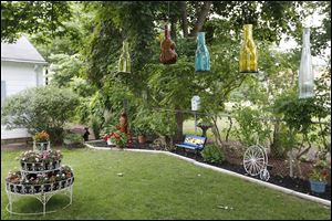 Yvonne Andrzejak’s  garden on Dudley Street in Maumee will be among eight shown during Toledo Day Nurs­ery’s an­nual gar­den tour, ‘‍In Another Garden,’ from 8 a.m. to 4 p.m. Saturday.