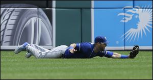 Kansas City Royals left fielder Alex Gordon catches the fly out hit by Detroit Tigers' J.D. Martinez during the fourth inning.