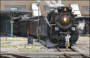 A train enthusiast photographs the front of the Nickel Plate 765, a historic steam locomotive built in the 1940s in Lima, Ohio, at the Central Union Terminal. The 765 passed through Toledo on its way to Michigan and offered tours of the train before it departed Wednesday afternoon.