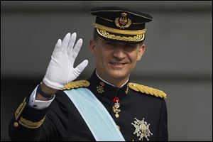 Spain’s newly crowned King Felipe VI waves upon his arrival at the Parliament in Madrid, Spain.