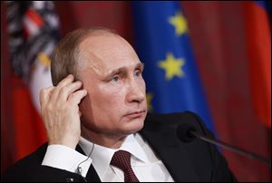 Russian President Vladimir Putin attends a news conference after his meeting with Austrian President Heinz Fischer in the Hofburg Palace in Vienna, Austria.