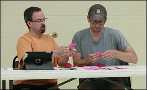 Executive committee members Troy Dowling, left, and Ryan Schueler count ballots during the meeting at the Maumee Senior Center to nominate Judge Peter Handwork and Patrick Kriner.