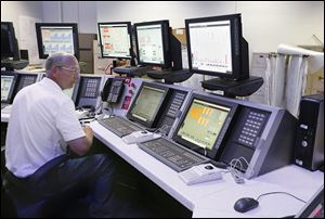 Above, John Schreiber of Monroe works in the control room. DTE Energy's coal-fired energy plant in Monroe is able to remove nitrous oxide and sodium dioxide with its new equipment. 