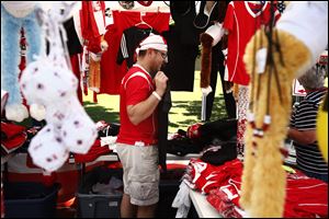 Chicago resident Adam Przybylski holds up a t-shirt in his tent of Polish clothing and accessories during last year's festival.