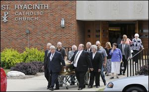 Gerald Robinson’s casket is rolled out of St. Hyacinth church in Toledo. Arrested in 2004 and convicted in 2006 for the murder of Sister Margaret Ann Pahl in 1980, the priest died in a prison hospice in Columbus on July 4.