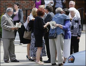 Mourners gather after services for Gerald Robinson at St. Hyacinth Catholic Church in Toledo. About 200 people attended on Friday.  Robin­son  re­ceived his First Com­mu­nion at the old St. Hya­cinth Church, and cel­e­brated his first Mass as an or­dained priest in 1964 at the cur­rent St. Hya­cinth on Parkside Bou­le­vard.