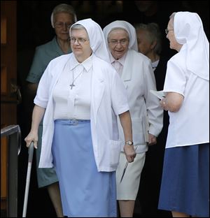 Nuns leave the funeral for Gerald Robinson at St. Hyacinth Church in Toledo. He was serving a sentence of 15 years to life when he died at age 76.