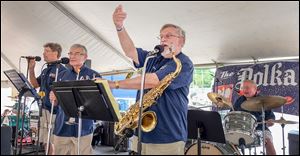 Ron Przybylski of the Polka Zone Band works the crowd during a performance Saturday in the heart of Toledo’s Polish International Village. The Polka Zone Band opened the day’s festivities at noon before giving way to the Ted Lange Band.