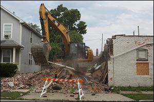 The building at 528 Magnolia St. in North Toledo where two city firefighters died battling a blaze Jan. 26 is demolished. It had been an apartment building and carryout, owned by Ray Abou-Arab.