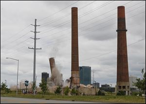 CTY implosion17p   The first of two smokestacks is imploded at the decommissioned Acme Power Plant at the East Toledo Marina District, Wednesday, July 16, 2014.  THE BLADE/ANDY MORRISON