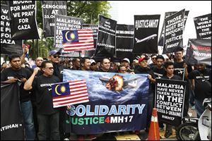 Protesters marched on the Russian embassy and Ukraine embassy in Kuala Lumpur today, waving placards and demanding justice for the victims of the Malaysia Airlines flight that was shot down over Ukraine last week.