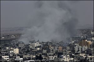 Smoke from Israeli strikes rises over Gaza City, in the northern Gaza Strip today. An Israeli aircraft struck dozens of Gaza sites, including five mosques it said were being used by militants, while several other areas came under tank fire.