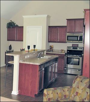 Maple-toned cabinets contrast nicely with stainless appliances. 