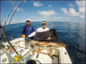 Toledo angler Scott Kozak shows off a Pacific sailfish he caught off Guatemala in December, 2013. The Whitmer grad is pictured with one of the mates.