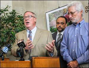 Mayor D. Michael Collins, along with Ed Moore, center, the public utilities director, and Dr. David Grossman, Toledo-Lucas County health commissioner, discuss Toledo’s water quality issues.