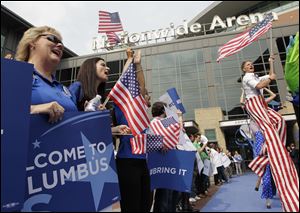 People cheer outside Nationwide Arena during a rally to welcome members of the technical advisory team from the Democratic National Committee today in Columbus. Columbus is among five cities competing for the 2016 Democratic National Convention. 