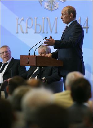 Russian President Vladimir Putin speaks at the meeting with Cabinet of Ministers and lawmakers Thursday in  the Black Sea resort of Yalta, Crimea.