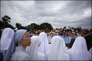 Nuns wait for Pope Francis before a closing Holy Mass of the 6th Asian Youth Day on Sunday in Haemi, South Korea.