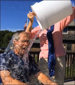 Former President George W. Bush participates in the ice bucket challenge with the help of his wife, Laura Bush, in Kennebunkport, Maine.