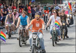 Scores of organizations, area businesses, politicians, and other supporters join the Toledo Pride parade.