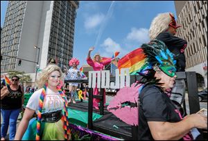 A float for the bar Mojo rolls down the street during the Toledo Pride parade.