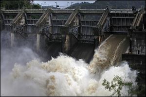 Water rushes through an open bay at the Carraizo Dam to release water left by a passing storm in Trujillo Alto, Puerto Rico.