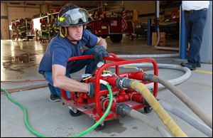 Waterville volunteer fireman Randy Mead charges the lines with water to test hoses at the fire department, which has 22 volunteers.