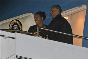 President Barack Obama and first lady Michelle Obama board Air Force One on Sunday at Cape Cod Coast Guard Air Station in Bourne, Mass.