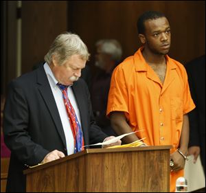 Public defender James MacHarg, left, and Michael Gaston at his arraignment today in Toledo Municipal Court.