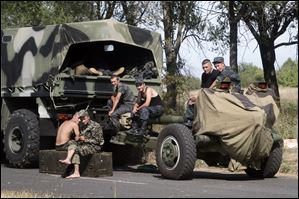 Ukrainian soldiers park their hardware on roadside as they wait for the start of the march into the town of Mariupol, eastern Ukraine.