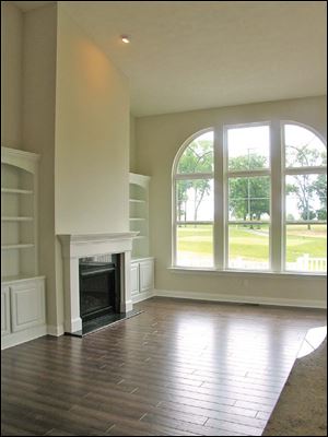 The dramatic windows allow natural light to reflect off the floor.