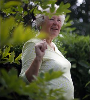 Susan Garn stands near the milkweed plants that the monarch caterpillars feed on at her Perrysburg home.