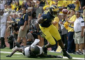 Appalachian State's Jordan Ford misses a tackle on Michigan's Devin Funchess.