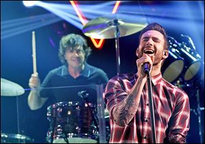 Drummer Matt Flynn and singer Adam Levine of Maroon 5 perform onstage during the iHeartRadio Album Release Party in Burbank, Calif.