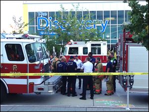 Firefighters confer out side the Nevada Discovery Museum in Reno, Nev., Wednesday where a minor explosion during a science experiment at the museum burned several children and forced the evacuation of the museum.