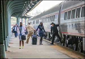 Passengers get off the Amtrak train Wednesday in Toledo. The train arrived six hours late, which is not uncommon these days for Am­trak’s over­night, long-dis­tance trains.