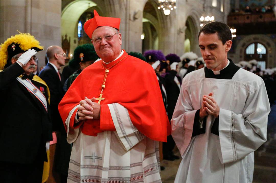 CTY-BIshop23Cardinal-Timothy-Dolan-smiles-as-he-is-led