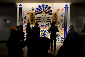 Docent John Duvall stands in front of Apollo, by Henri Matisse, as he prepares to take visitors on a flashlight tour.