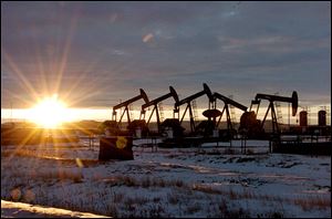 Oil rigs pump out crude in the Bakken shale field in western North Dakota.