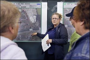 Denise Koch-Vargo talks to her neighbors, who live on Selkirk Street, during a public meeting at Westfield School on ODOT’s latest plans for I-75. Part of the project would extend Selkirk Street, making it no longer a dead-end, prompting concerns about traffic. 